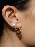 Pierced Huggies pictured on models ear in middle piercing 