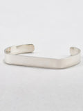 Sterling Silver Flat ID Cuff Bracelet pictured on light grey background.