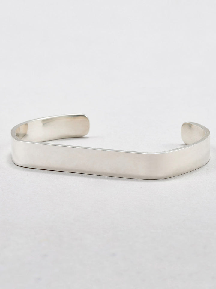 Sterling Silver Flat ID Cuff Bracelet pictured on light grey background.