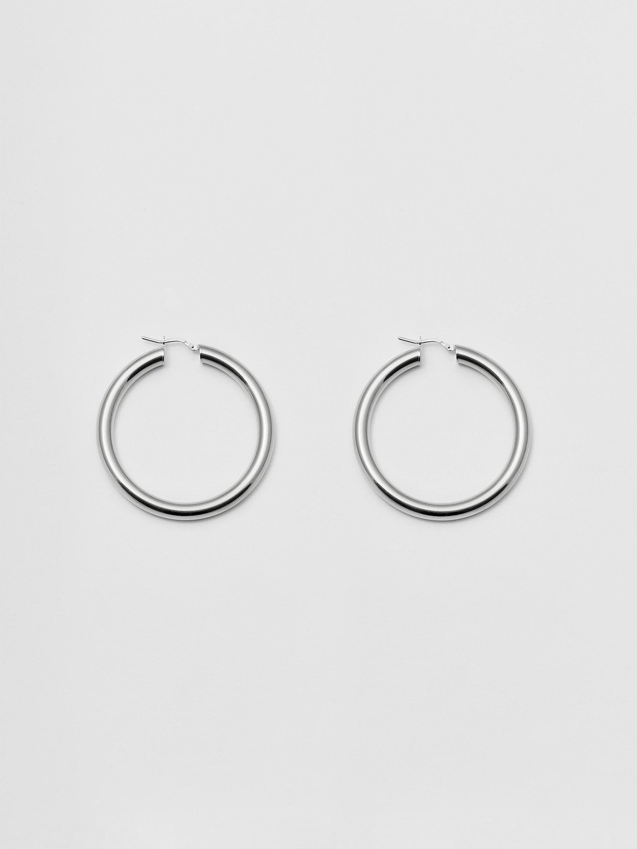 Product shot of the Tru Hoops in Sterling Silver (Sterling Silver Hoops 49.5mm diameter  5mm thick) Background: Grey backdrop