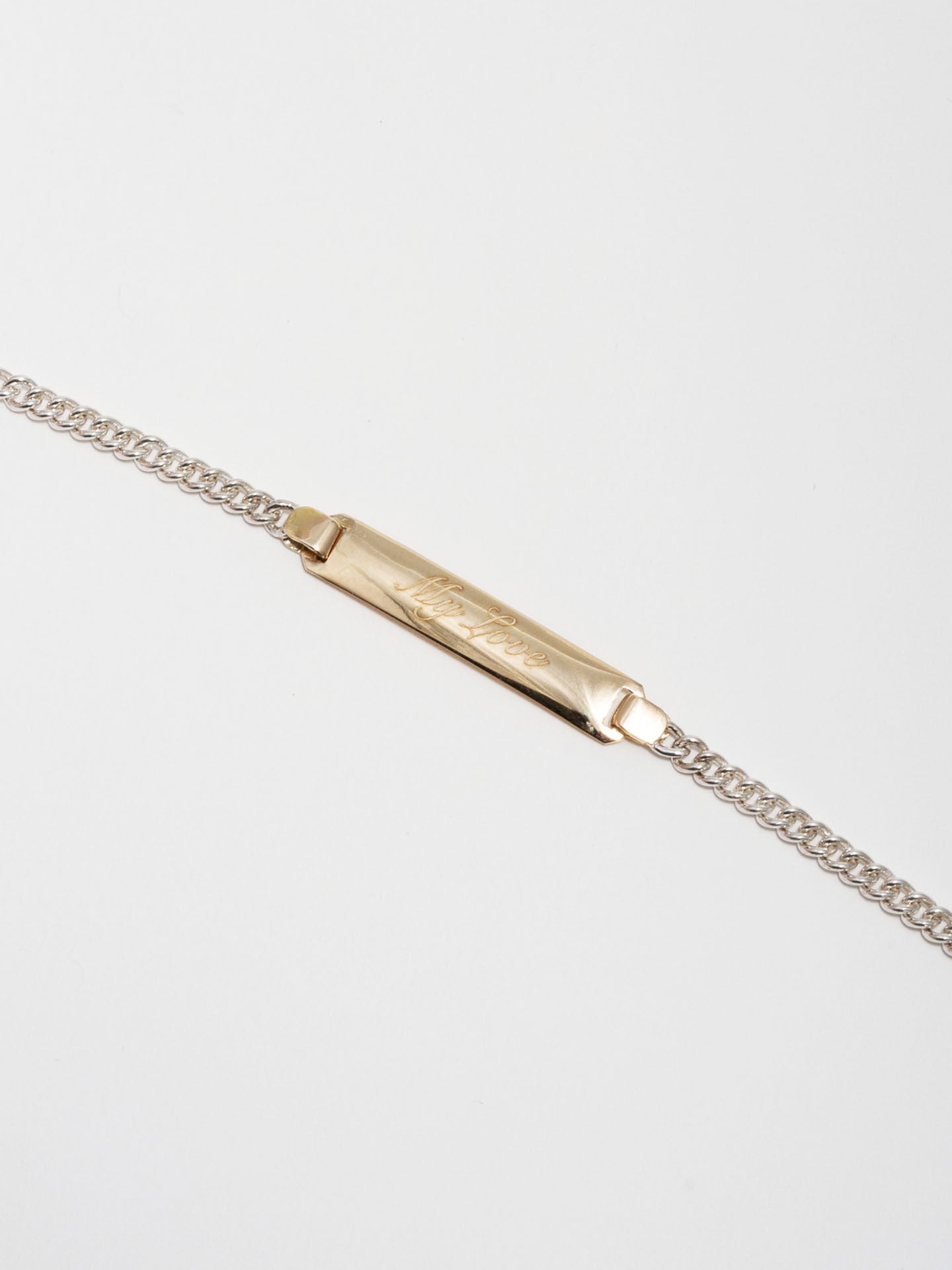 14kt Yellow Gold and Sterling Silver ID Bracelet engraved with 'My Love' in Script Font. Light grey background. 