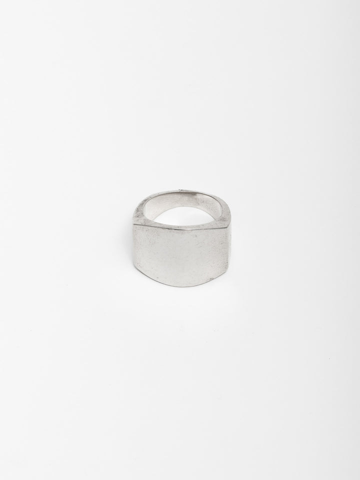Sterling Silver ID Ring pictured on light grey background.