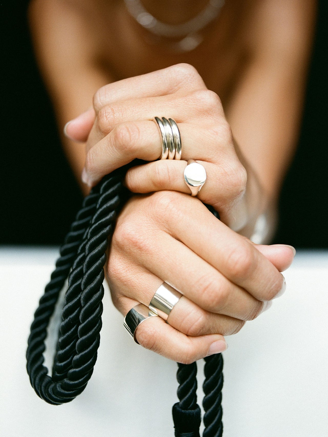 Close up shot of Sterling Silver Tube Ring pictured stacked on models index finger.