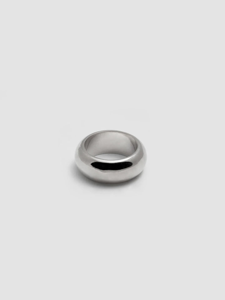 A sterling silver band pictured on light grey background.