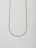 Close up of Solid 14kt Yellow Gold Lightweight Rope Chain on light grey background.