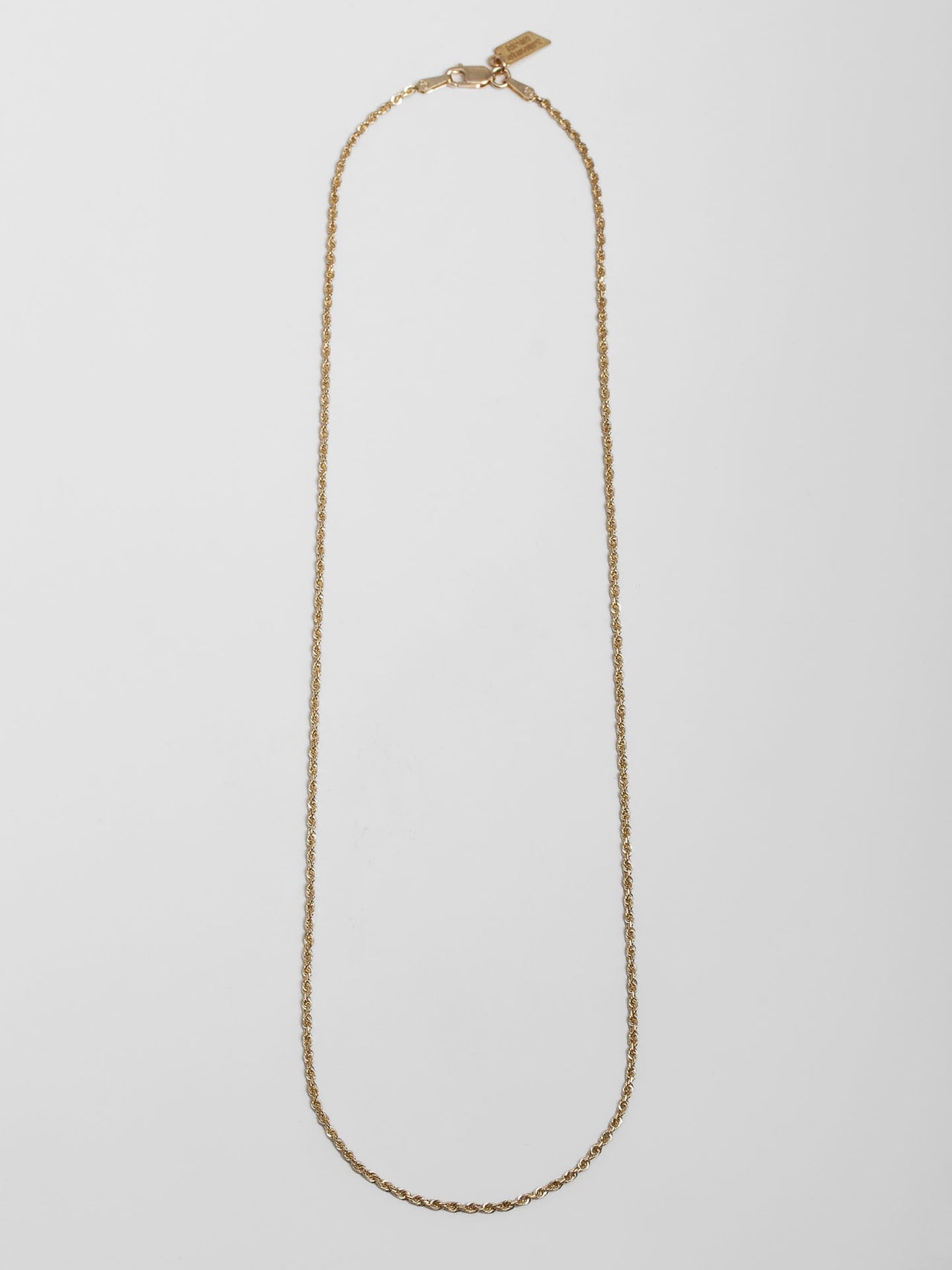 Solid 14kt Yellow Gold Lightweight Rope Chain pictured on light grey background.
