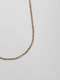 Close up side angle of Solid 14kt Yellow Gold Lightweight Rope Chain pictured on light grey background.