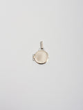 Mixed Metal Locket Pendant pictured closed on light grey background.