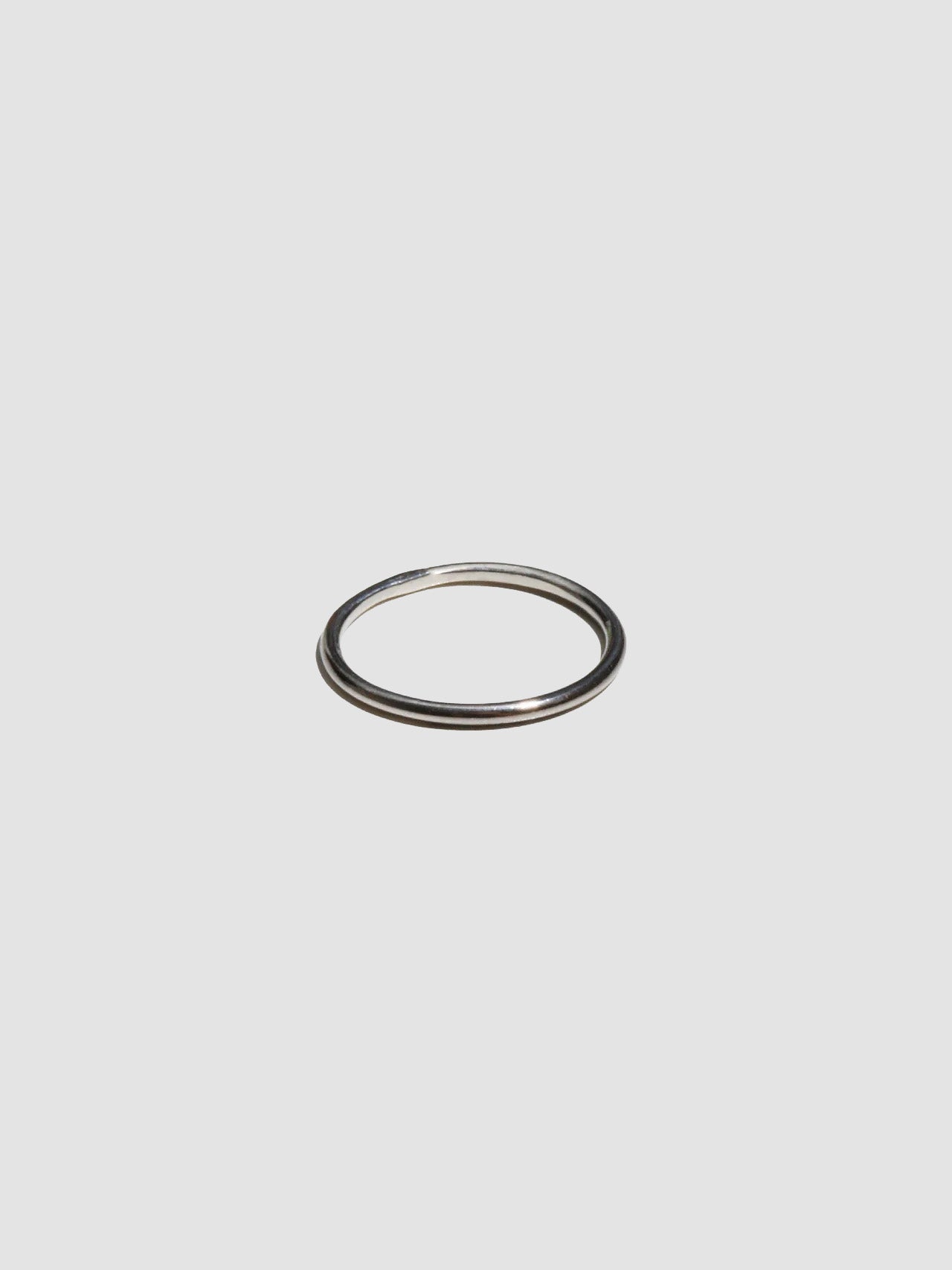 A sterling silver ring pictured on light grey background.