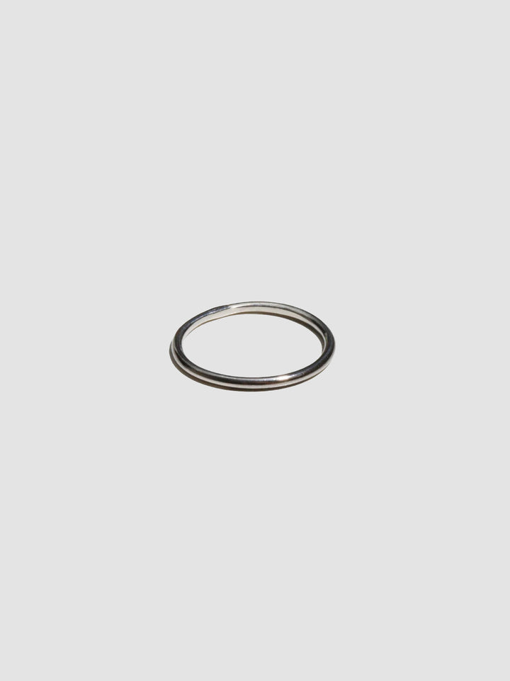 A sterling silver ring pictured on light grey background.