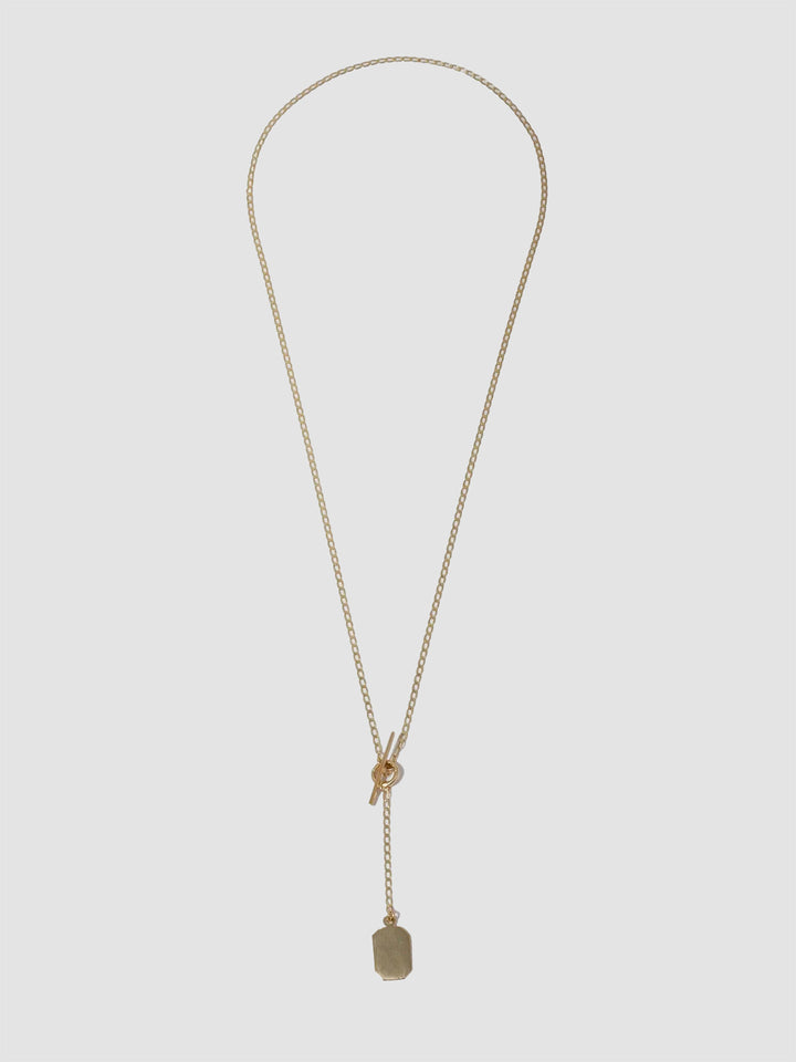 A 14kt yellow gold octagonal ID toggle lariat necklace with a sculptural ID tag and a bold toggle closure. The necklace is designed for layering and has a lariat drop.