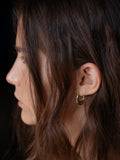 14kt Yellow Gold Dome Hammock Hoops pictured on model. Black background.