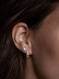 14kt Yellow Gold Pierced CZ Huggies pictured on models ear.