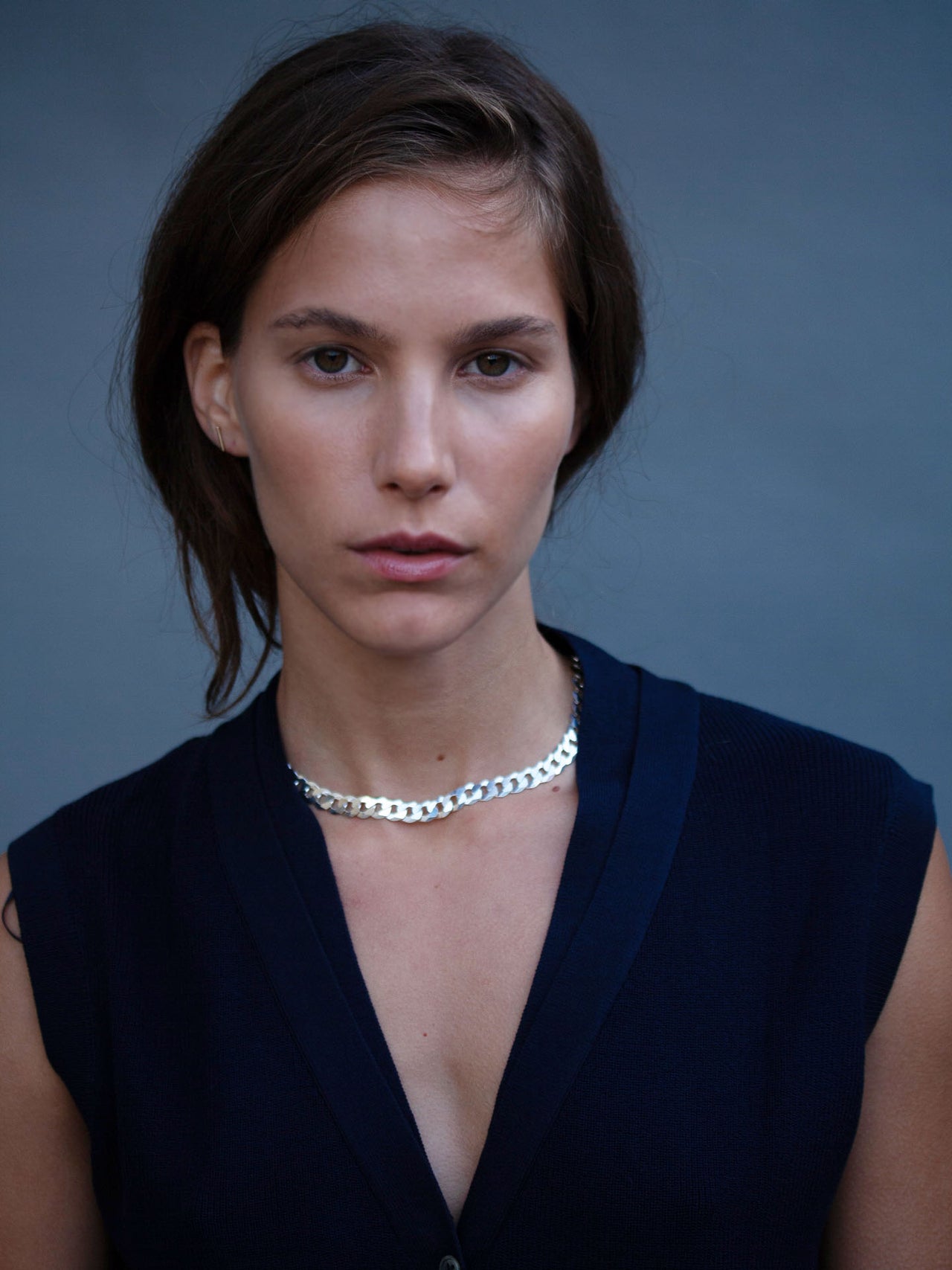 Sterling Silver Flat Curb Chain pictured on model. Light blue background.