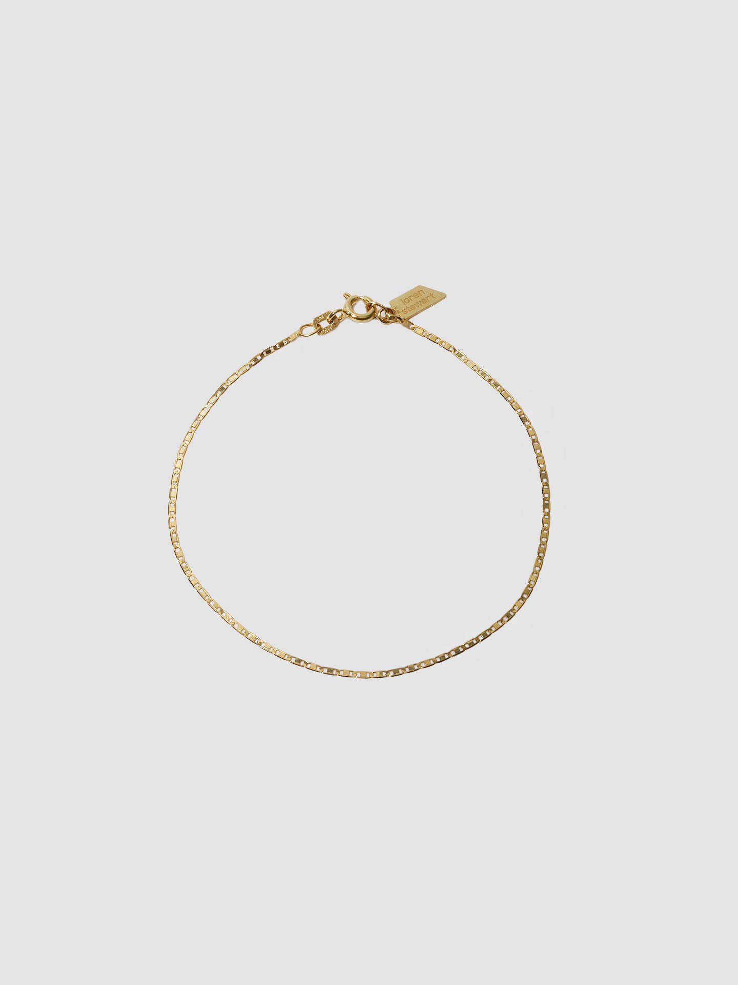 10kt Yellow Gold Valentino Chain Bracelet pictured on light grey background.