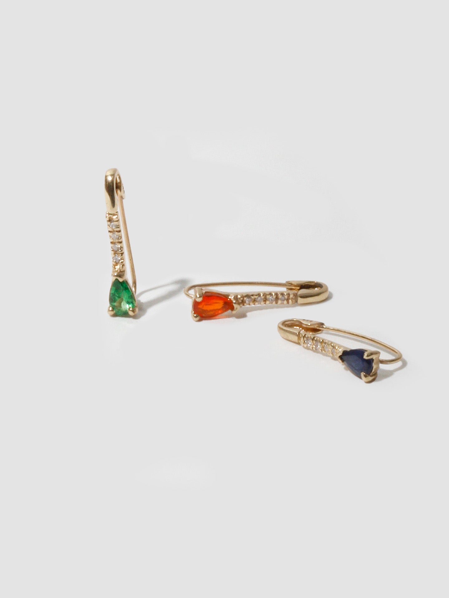 14kt Yellow Gold Mini Diamond Fire Opal Safety Pin pictured with the Tsavorite and Dark Blue Sapphire. 