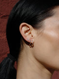 14kt Yellow Gold Square Diamond Click-in Huggies pictured on model in first piercing. 