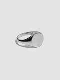 Silver ring on a light gray background