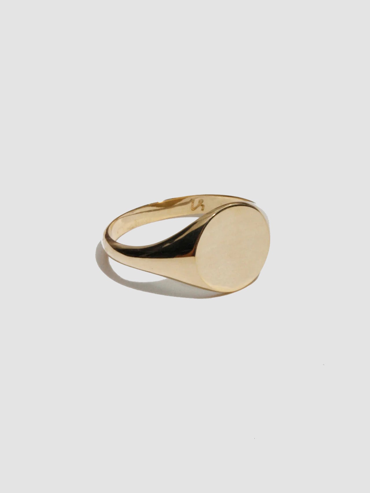 Gold ring on a light gray background