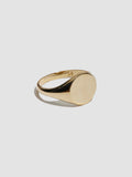 Gold ring on a light gray background