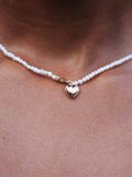 14kt Yellow Gold Puff Love Pearl Choker pictured on model. Close up shot. 