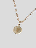 14Kt Yellow Gold Mini Disk Pendant pictured engraved with letter 'L' in Script Font. 