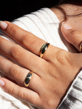 14kt Yellow Gold Emerald Baby Band pictured on models pointer finger.