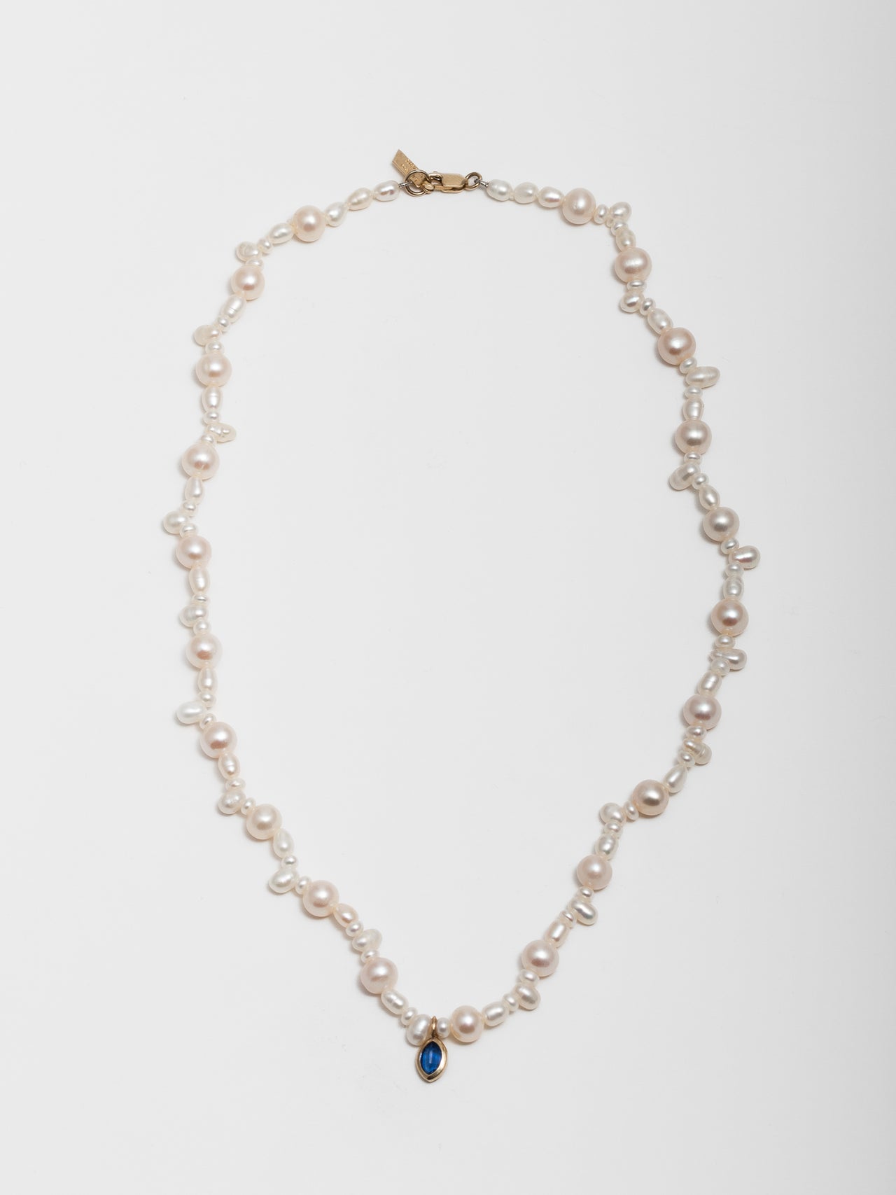 14kt Yellow Gold Pearl & Gemstone Necklace pictured on light grey background.