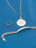 Sterling Silver Industrial ID Bracelet pictured on blue background along with a necklace and ring. 