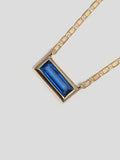 Product image of 10kt yellow gold thin chain necklace with thin green rectangular gemstone on white background.