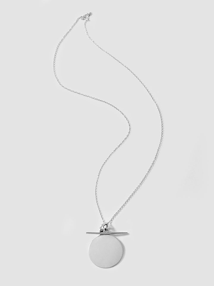 Sterling Silver Disk and Toggle pictured on light grey background.