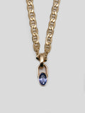 Close up of 14kt Yellow Gold Padlock Gem Necklace pictured on light grey background.