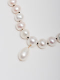 Close up of 14kt Yellow Gold Boujee Pearl Strand's Baroque Pearl pendant.