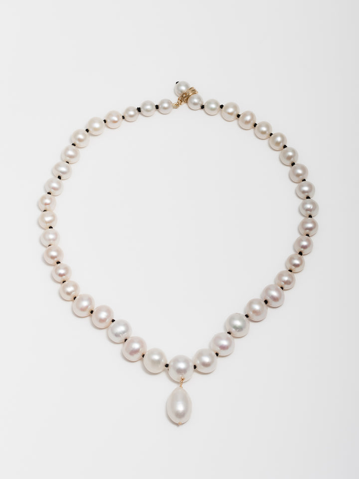 14kt Yellow Gold Boujee Pearl Necklace or Bracelet pictured on light grey background.