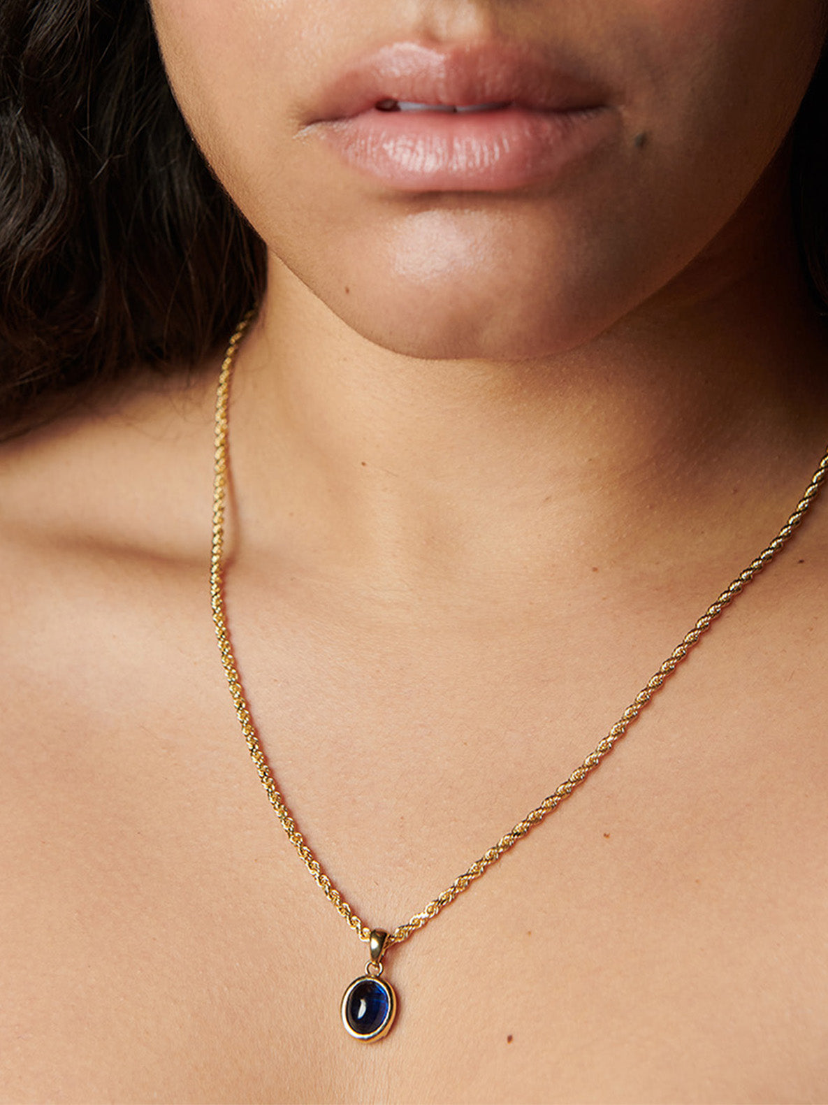 Close up of 14kt Yellow Gold Cielo Amulet Pendant on model.