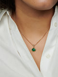 Close up of 14kt Yellow Gold Edan Amulet Pendant pictured on chain around models neck. 