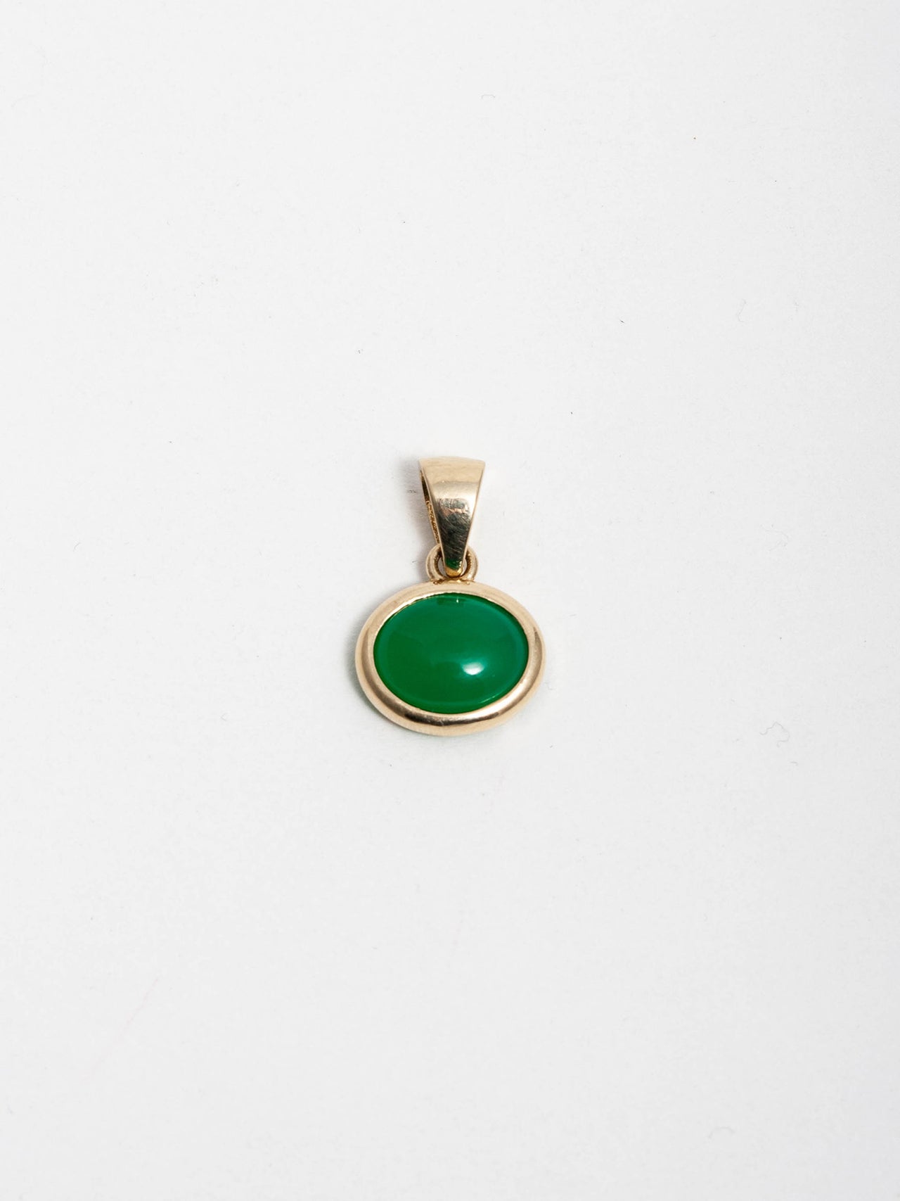 14kt Yellow Gold Edan Amulet Pendant pictured on light grey background. 