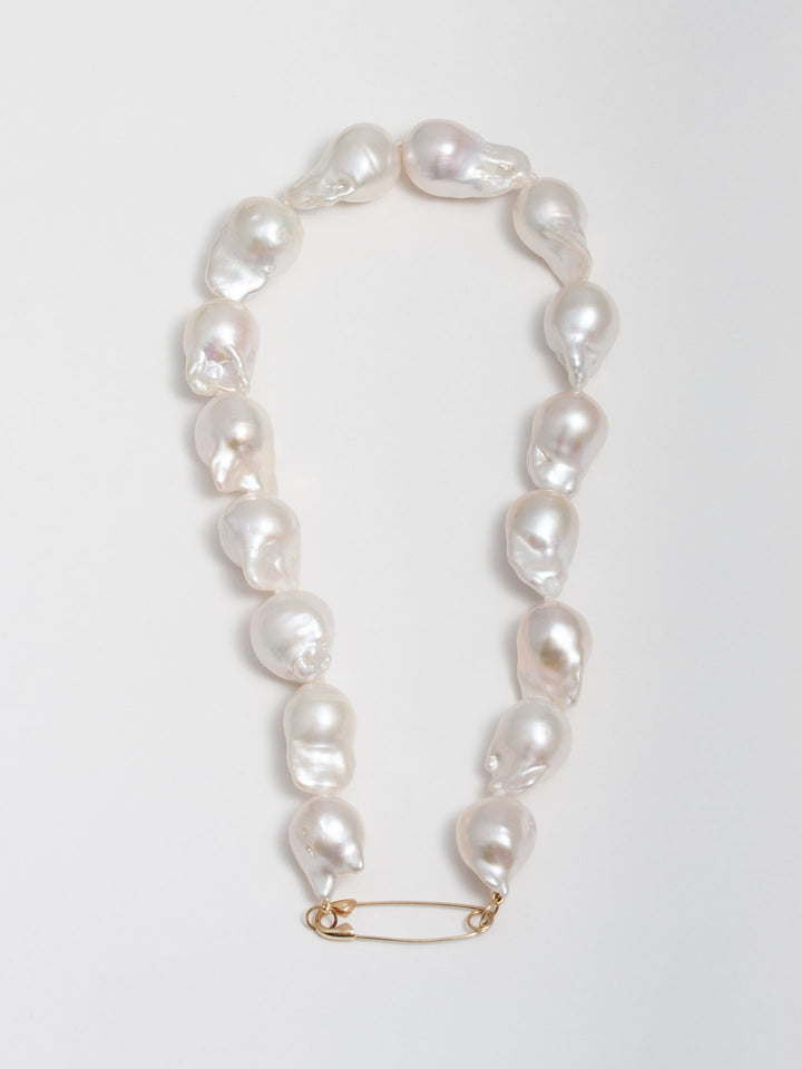 14kt Yellow Gold Safety Pin Baroque Pearl Collar pictured on light grey background.