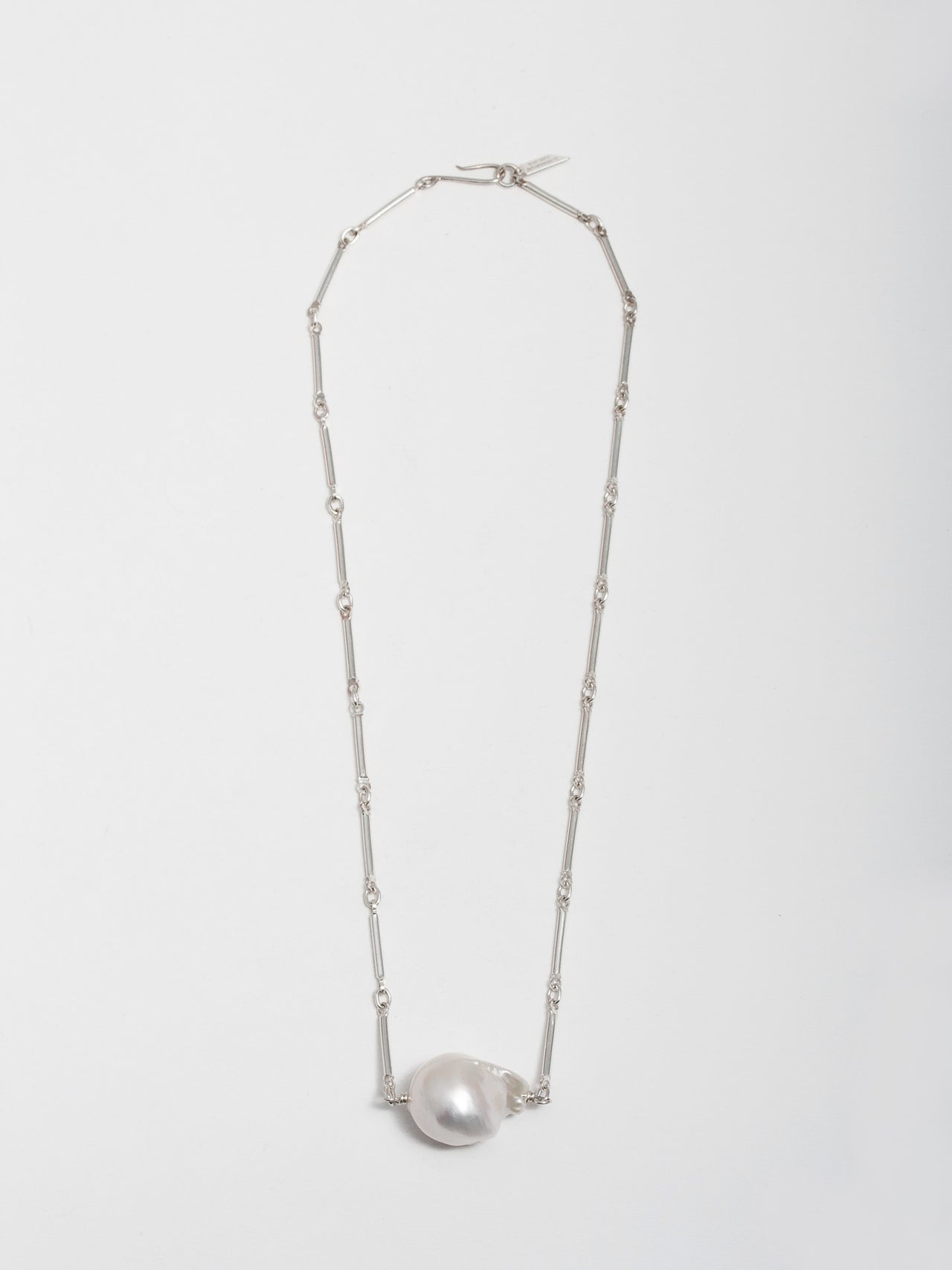 Sterling Silver Bar Link Chain & Pearl Necklace pictured on light grey background. 