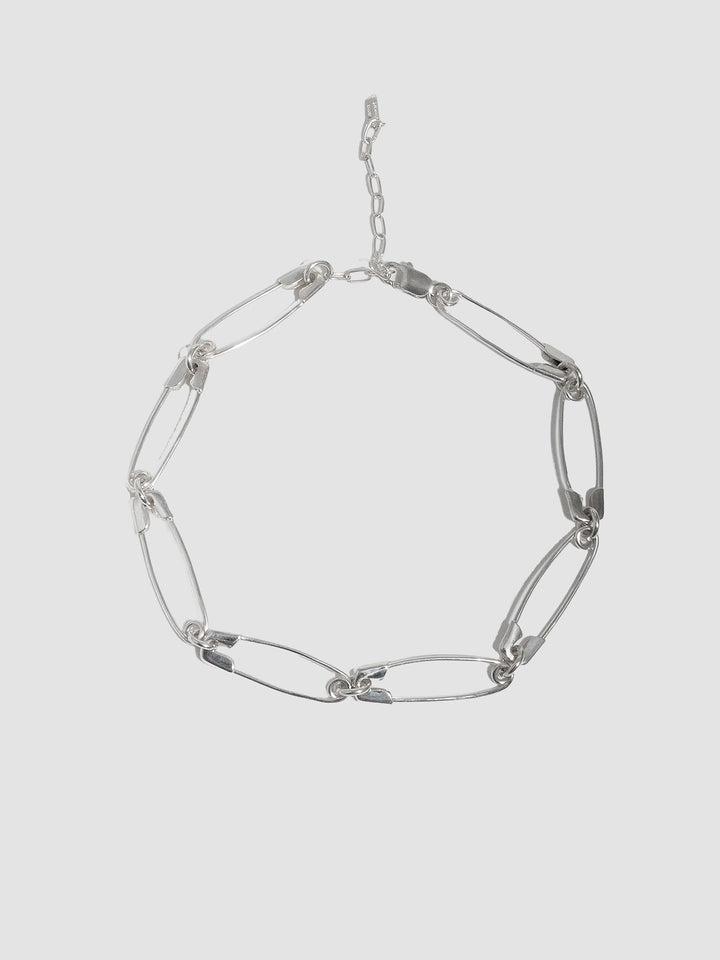 Sterling Silver Safety Pin Link Chain pictured on light grey background. 