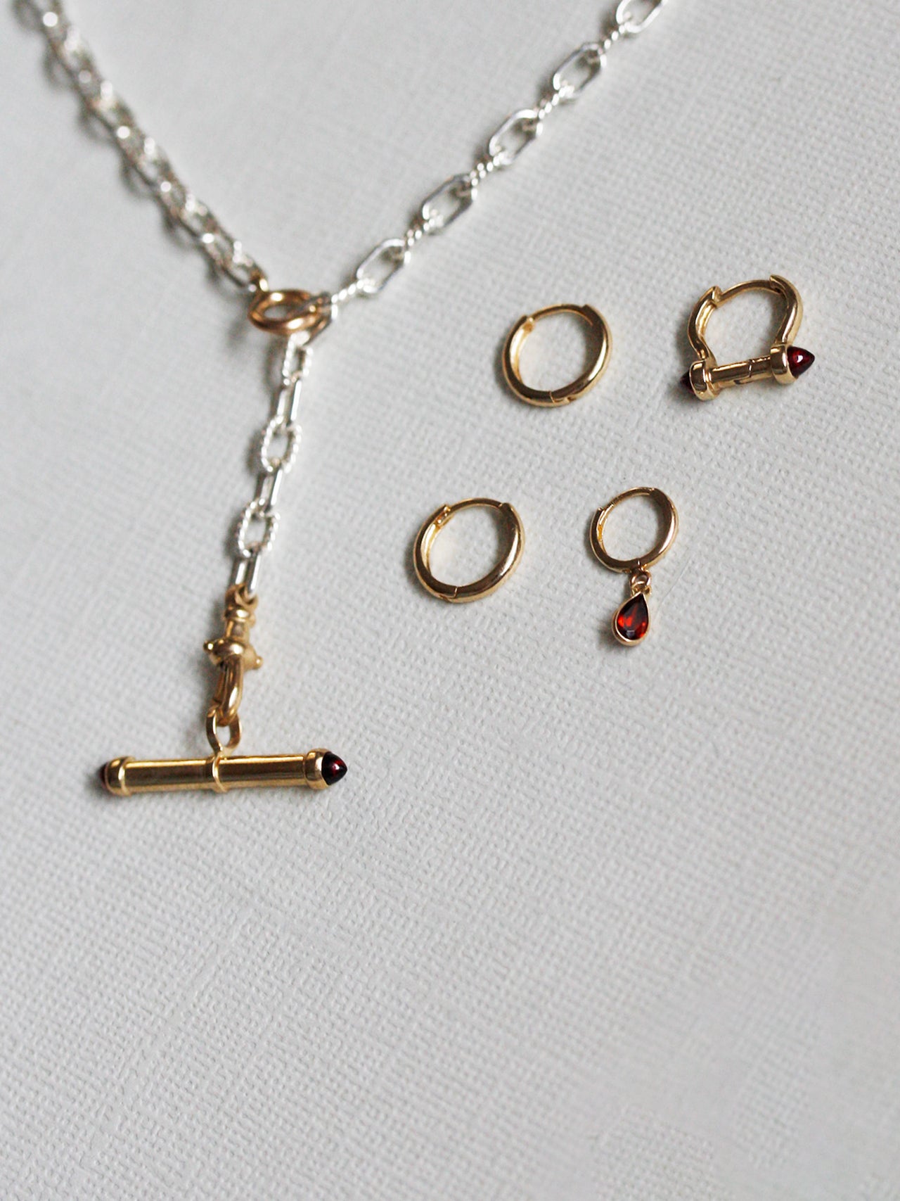 Jewelry set with necklace and earrings on a light gray background