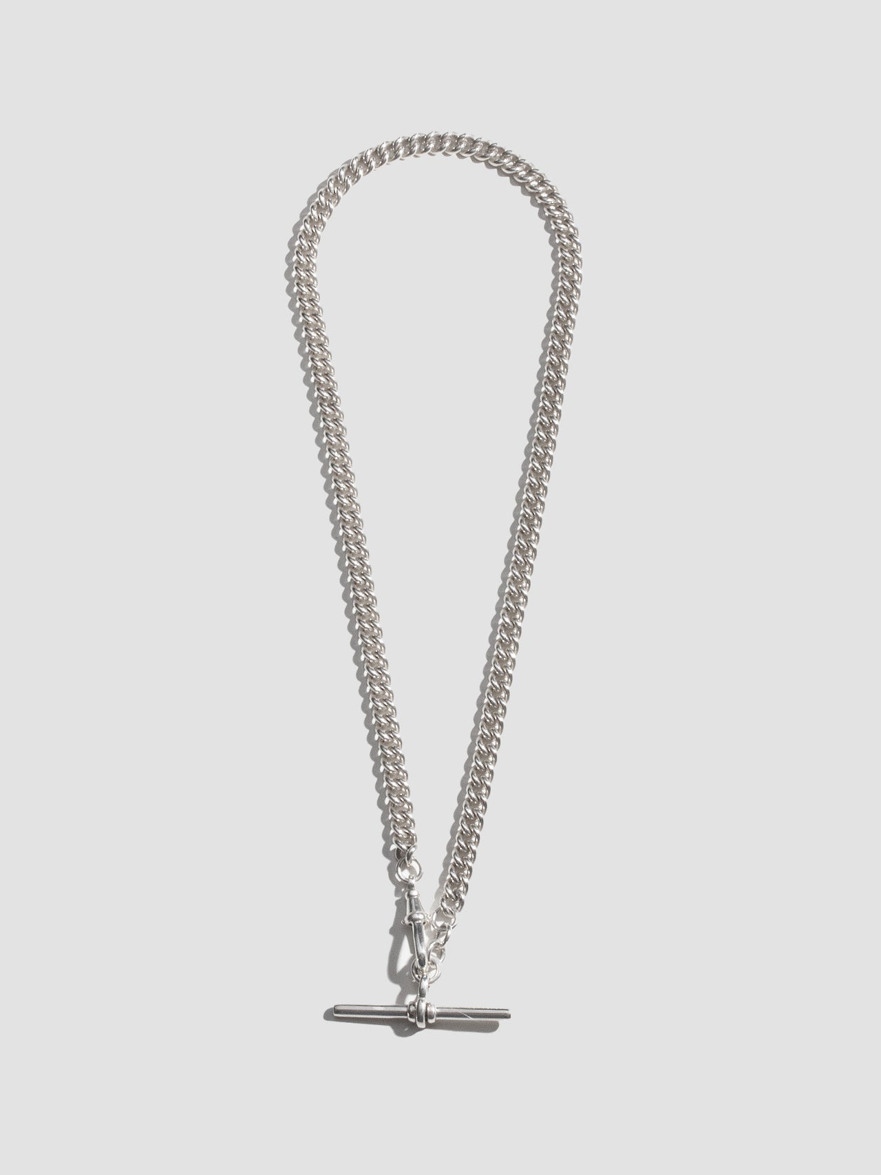 Sterling Silver Industrial T-Bar Curb Chain Necklace pictured on light grey background. Full frame. 