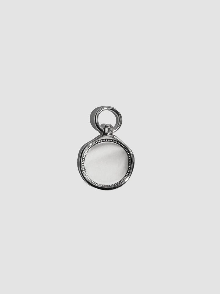 Silver pendant on a light gray background