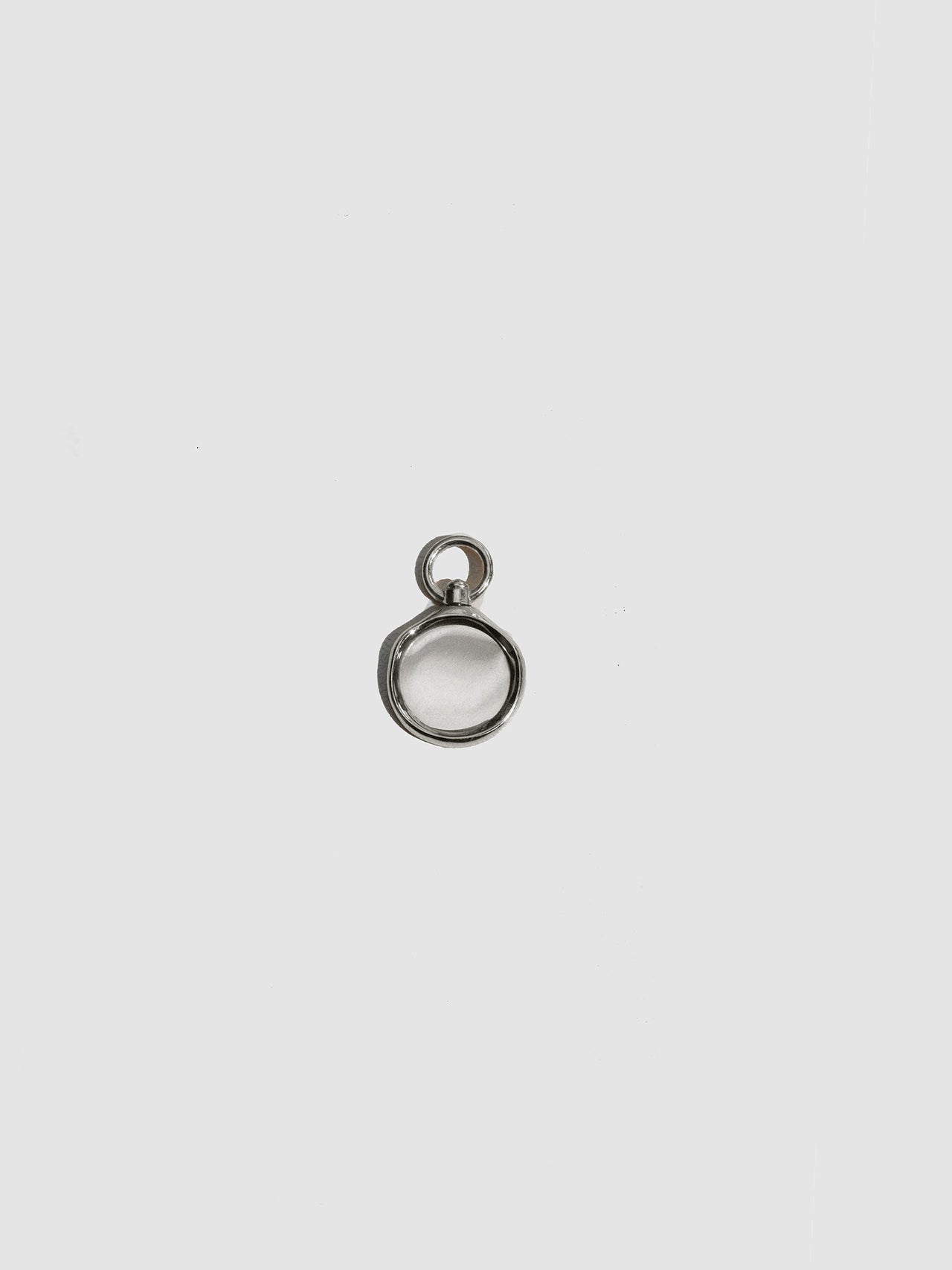 Small silver pendant on a light gray background