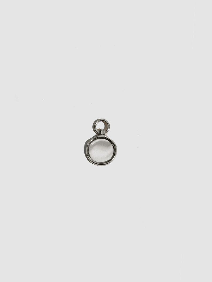 Small silver pendant on a light gray background