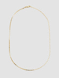 Gold necklace on a light gray background