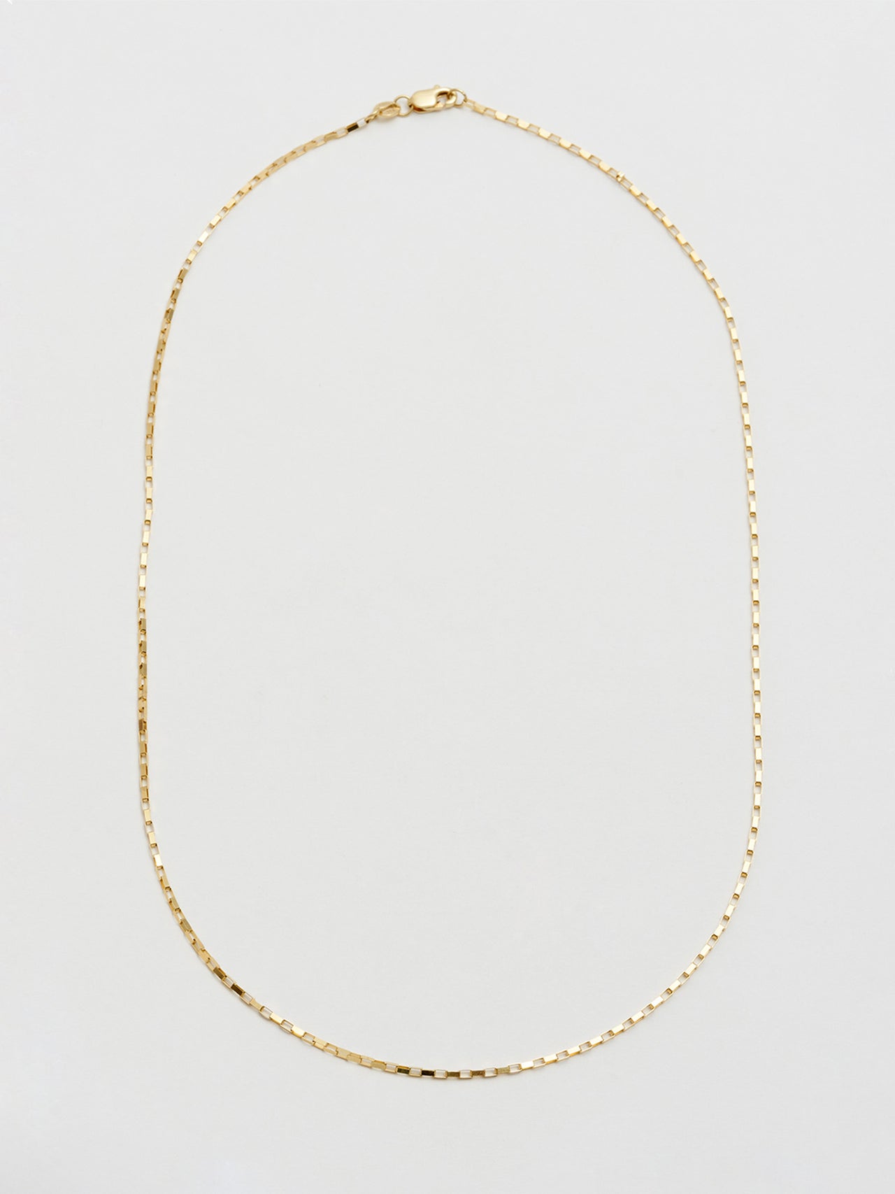 14Kt Yellow Gold Elongated Box Chain pictured on light grey background