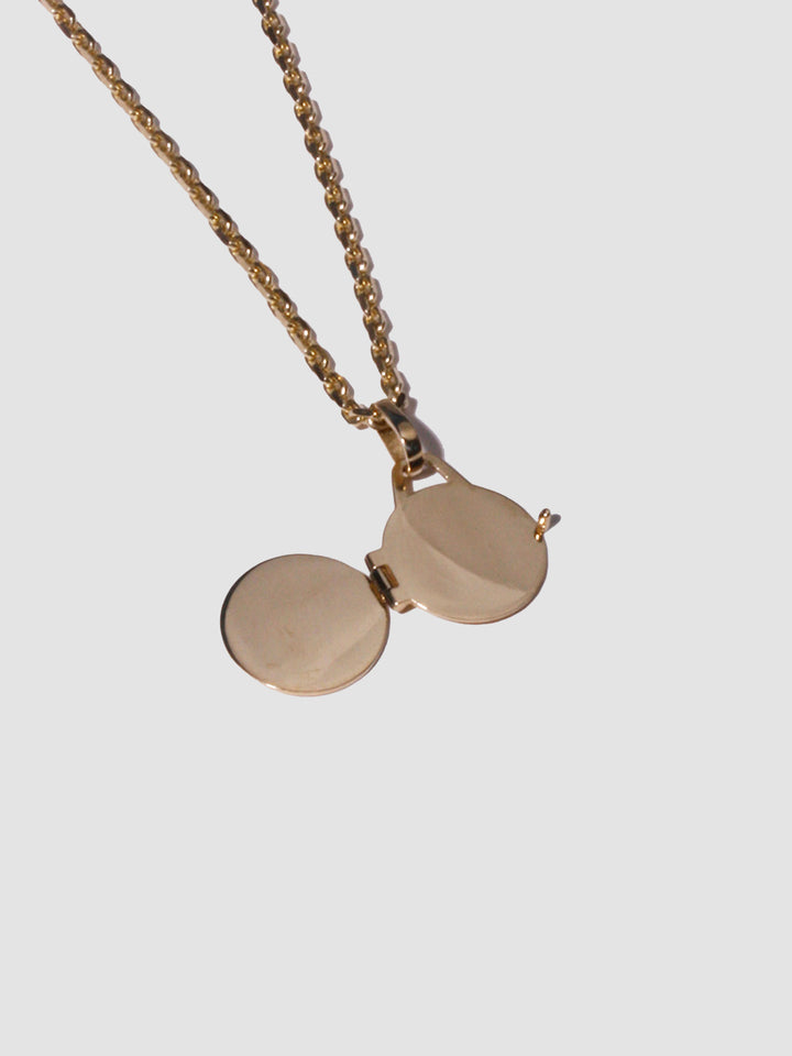 14kt Yellow Gold Locket Pendant shot on light grey background.