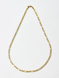 14kt Yellow Gold Hollow Figaro Chain pictured on light grey background.