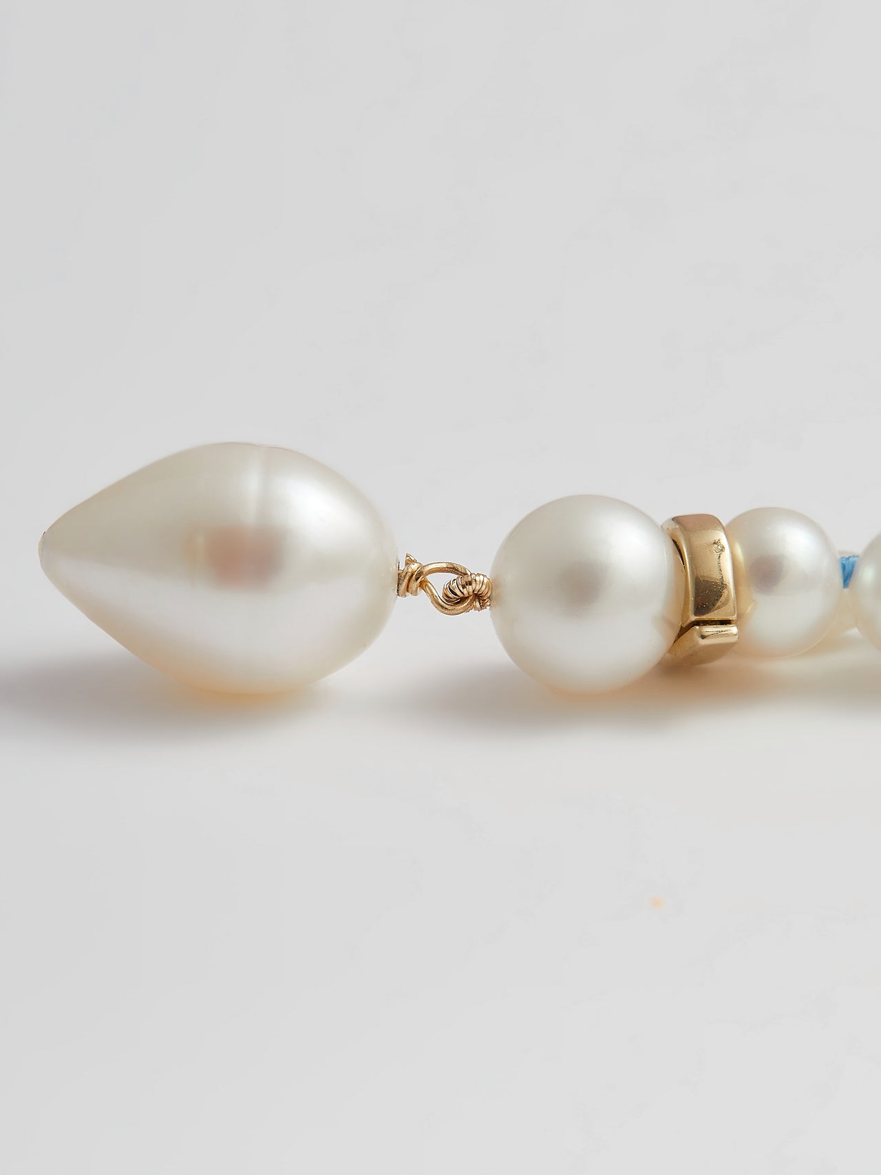 14kt Yellow Gold Pearl Necklace pictured up close of dovetail pearl drop. 